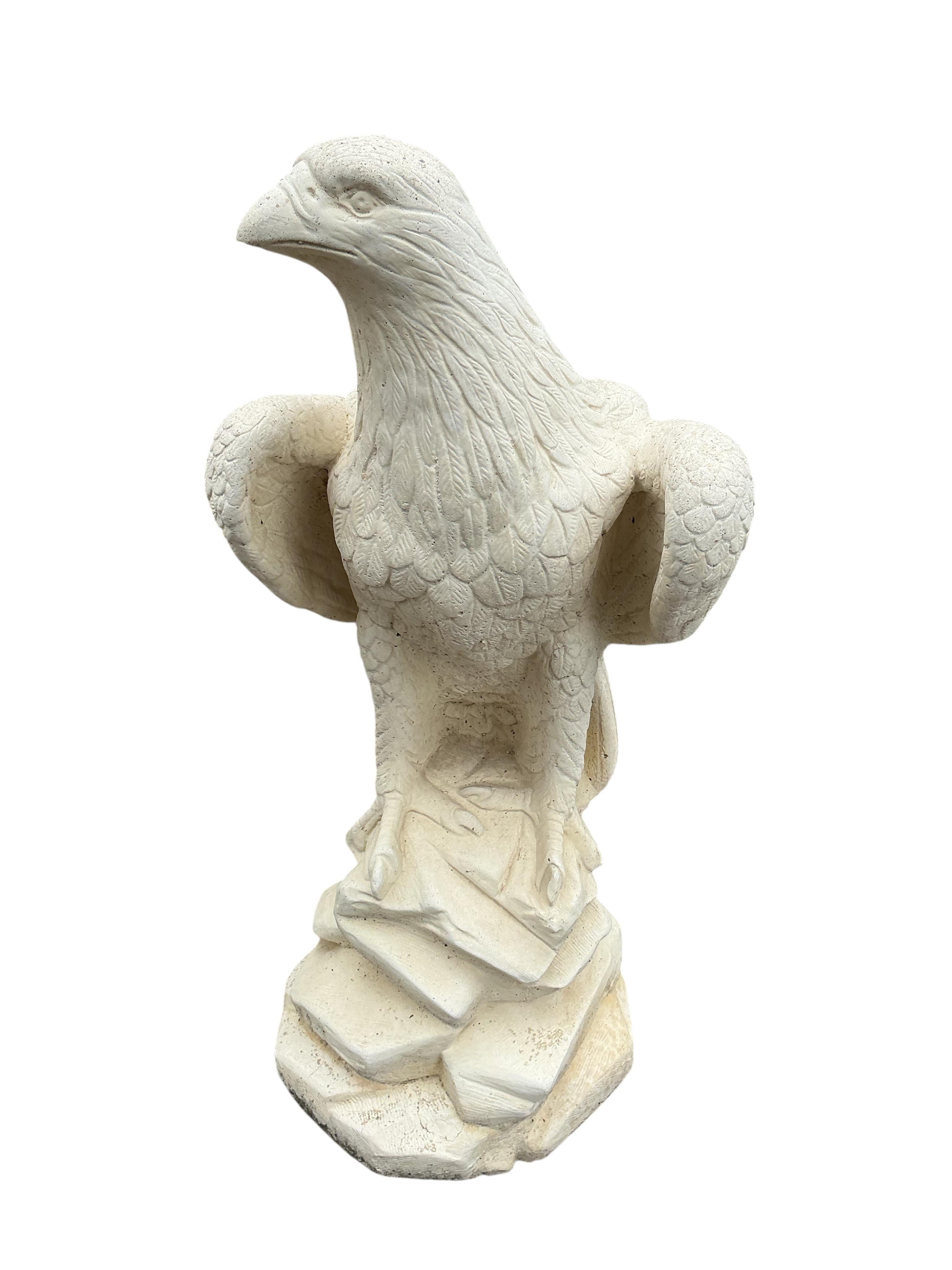 A pair of reconstituted stone eagle garden ornaments, height 60cm